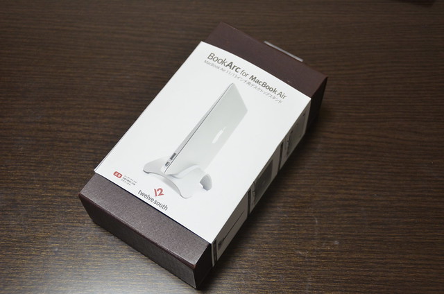 The box for the BookArc for MacBook Air on a dark wooden desktop.